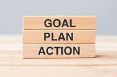 istock wooden block with GOAL, PLAN and ACTION on table background 1328665298