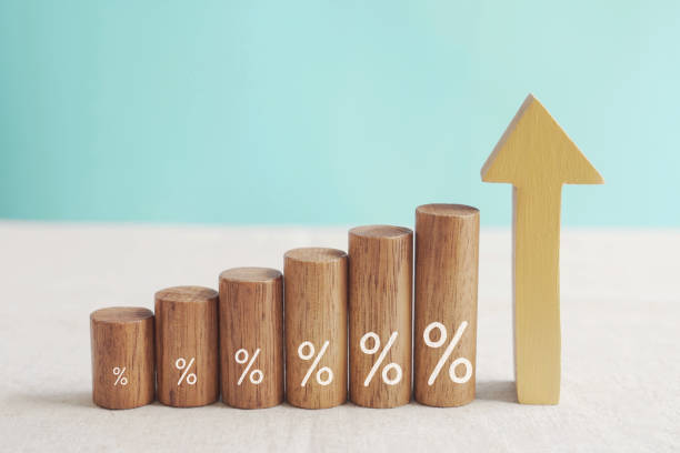 Wooden blocks with percentage sign and arrow up, financial growth, interest rate and mortgate rate increase, inflation concept stock photo