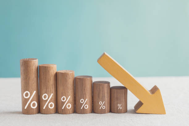 Wooden blocks with percentage sign and down arrow, financial recession crisis, interest rate decline, risk management concept  crumble stock pictures, royalty-free photos & images
