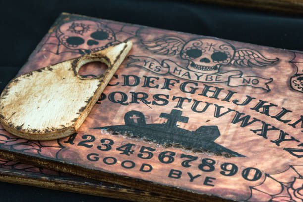 Wooden Board Ouija: Communication with Spirits Pisa, Italy - may 2015: Wooden Board Ouija: Communication with Spirits. Image taken In Public Street in Vicopisano in Pisa (Italy) during annual Medieval Festival ouija board stock pictures, royalty-free photos & images