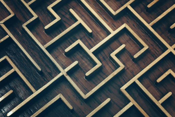 Wooden brown labyrinth maze puzzle close up Close up of dark brown wooden labyrinth maze, toy puzzle game, elevated high angle view maze photos stock pictures, royalty-free photos & images