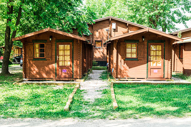 Wooden bungalows on campsite camping Wooden bungalows on campsite camping. Green trees bungalow stock pictures, royalty-free photos & images