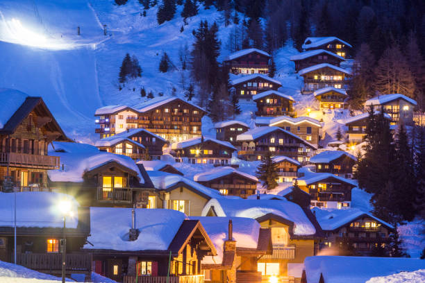 Wooden chalets covered with deep snow  at the blue hours stock photo