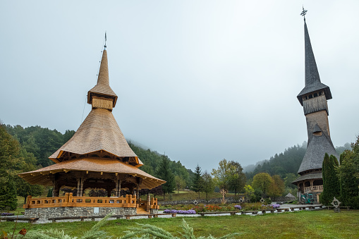 Barsana, Romania - Sep 26, 2018:  Recent roof made with dovetailled wooden shingles, displays the typical, tall form of religious buildings in the Maramures region of Romania