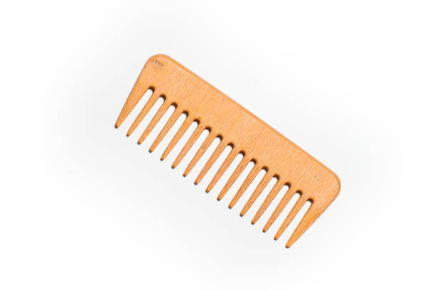 Wooden comb on a white background stock photo