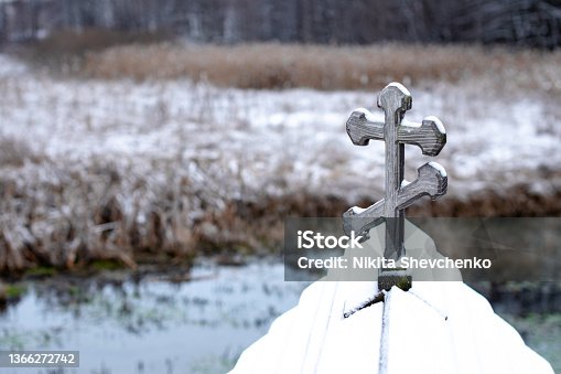 istock wooden cross on the roof of the font 1366272742