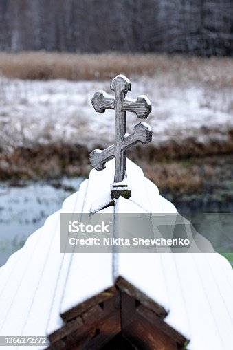 istock wooden cross on the roof of the font 1366272772