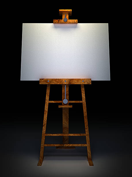 Wooden easel with blank canvas isolated on black stock photo