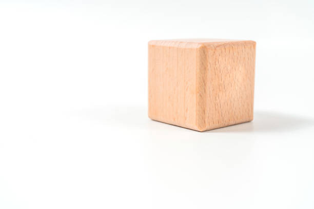 wooden geometric shapes cube isolated on a white background wooden geometric shapes cube isolated on a white background asien startblock stock pictures, royalty-free photos & images