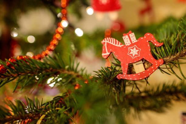 wooden horse decoration on christmas tree stock photo