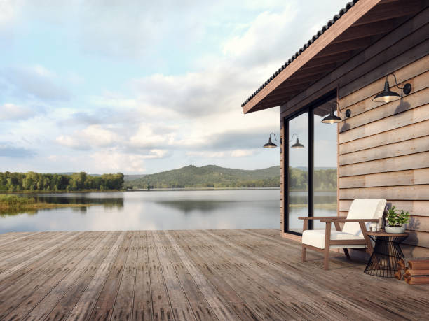Wooden house exterior with beautiful lake and mountain view 3d render stock photo