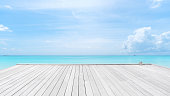 istock Wooden jetty on turquoise sea with clear sky background 1369242656