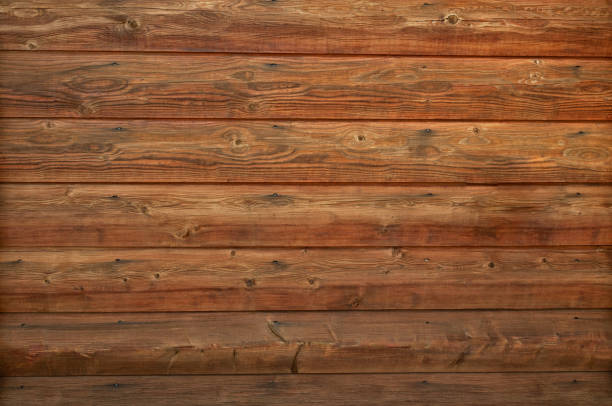 Wooden log cabin texture - interior design in traditional houses. Abstract background with horizontal lines and natural wood pattern with knots on a log wall. stock photo