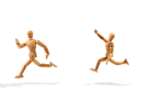 Wooden mannequin runs waving after another