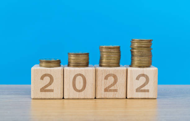 2022 wooden numbers with coins on the table stock photo