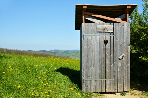 Wooden outhouse in the middle of park Wooden outhouse in the middle of park aargau canton stock pictures, royalty-free photos & images
