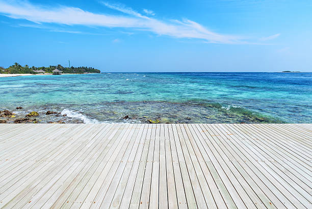 Wooden platform beside tropical green lagoon stock photo
