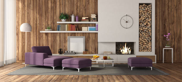Wooden room with white fireplace and purple furniture stock photo