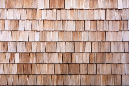 Closeup of a wall covered with wooden shingles