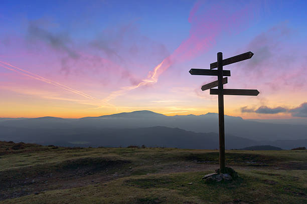 wooden signpost on mountain wooden signpost on mountain at sunset directional sign stock pictures, royalty-free photos & images