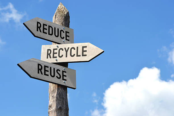 Wooden signpost - reduce, recycle, reuse stock photo