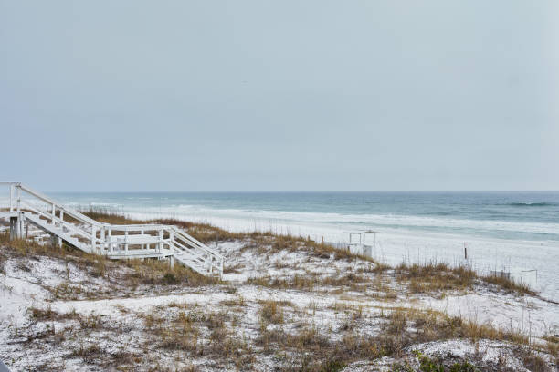Wooden stairway leads over dunes to white sand beach, Destin stock photo