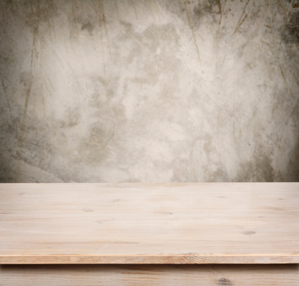 Wooden table on defocuced vintage wall background