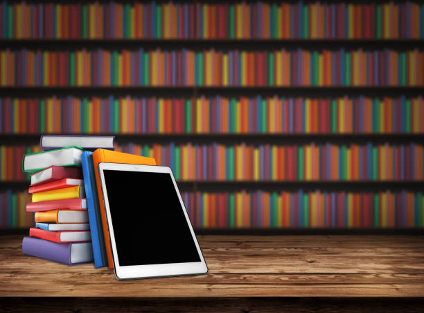 Wooden table with a stack of colored books and tablet. Blurred background with bookshelves. Table top with books in the library. Back to school. Background design element, banner, poster. 3d render stock photo