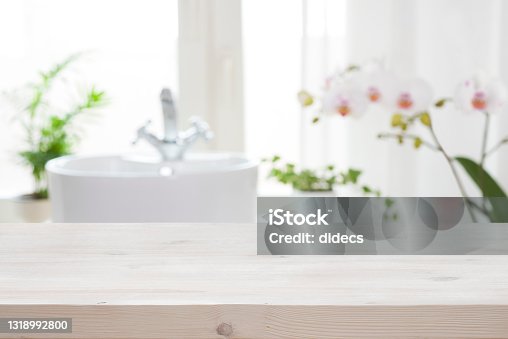 istock Wooden tabletop for product display on blur bathroom interior background 1318992800