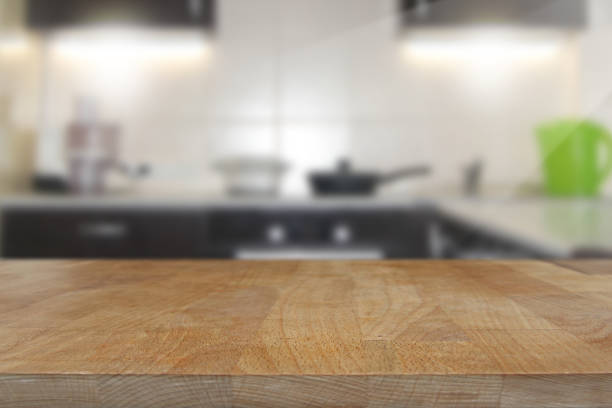 Wooden top table with blurred kitchen interior background stock photo