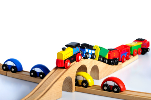 wooden train toy with wagons on railway bridge