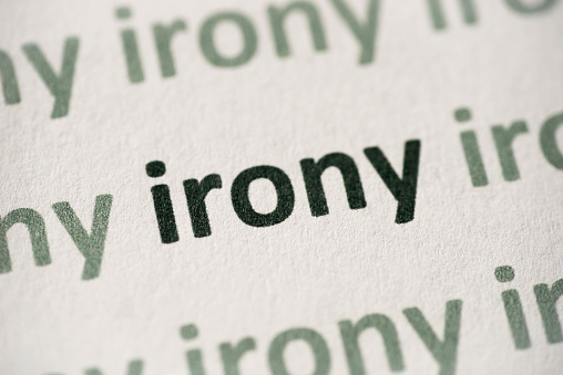word irony printed on white paper macro