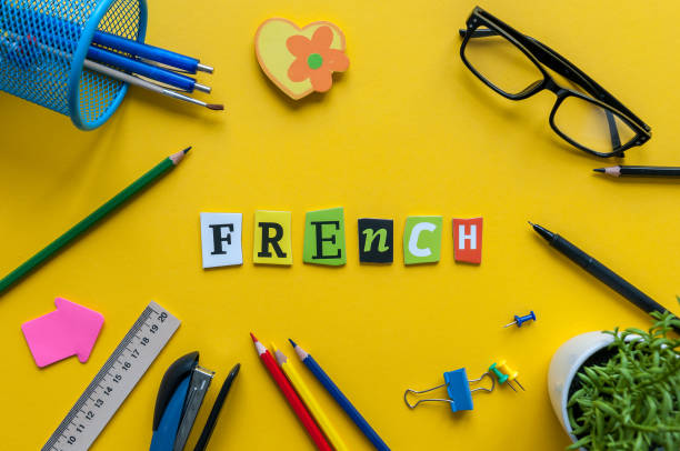 French Word Made With Carved Letters On Yellow Desk With Office Or