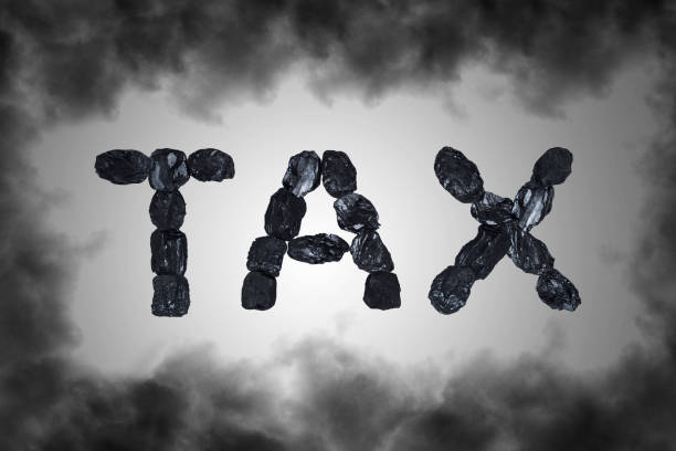 Word Tax  with industrial black smoke. Taxes and taxation. stock photo