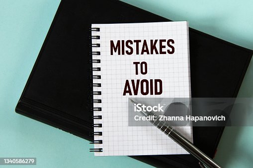istock MISTAKES TO AVOID - words in a white notebook against the background of a black notebook with a pen 1340586279