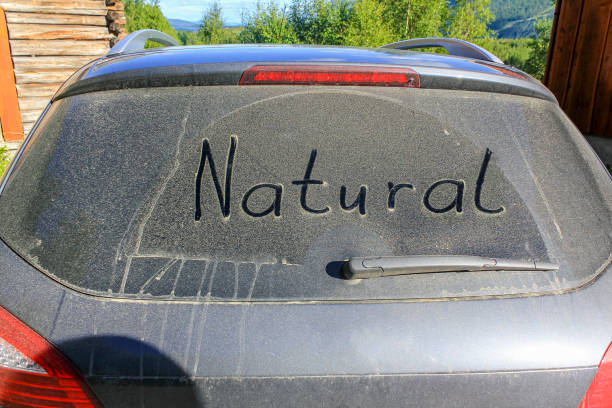 Words NATURE on the dusty, dirty windscreen of a car stock photo