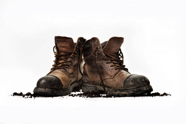work boots - muddy shoes stockfoto's en -beelden