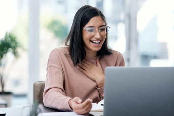 Work hard and your win will come around Shot of a young woman using a laptop and looking surprised while working from home thank you phrase stock pictures, royalty-free photos & images