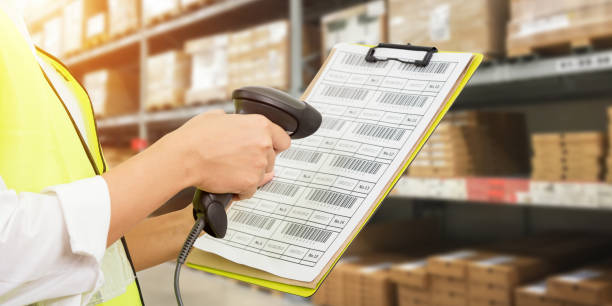Worker checking and scanning package by laser barcode scanner Worker checking and scanning package by laser barcode scanner in modern warehouse. af_istocker stock pictures, royalty-free photos & images