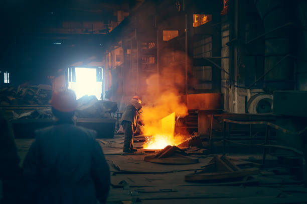 Worker in blast furnace. Metallurgical plant. Industrial steel production. Interior of metallurgical workshop stock photo