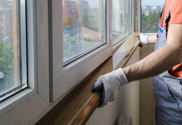 Worker is installing a window sill. Worker is installing a window sill on a polyurethane foam. replacement stock pictures, royalty-free photos & images