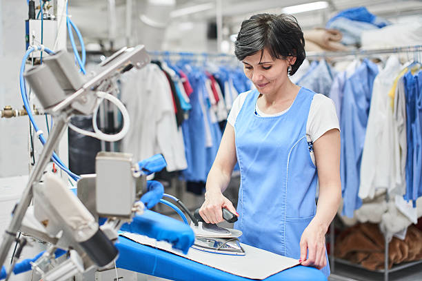 Worker Laundry ironed clothes iron dry stock photo