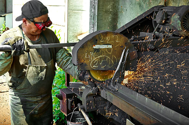 Worker performs work on metal, sparks stock photo