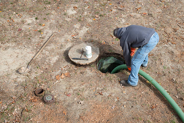 Worker Pumps Residential Septic Tank for Home Improvement stock photo