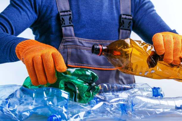 Worker sorting plastic garbage for recycling. Process plastic polymers sorting. stock photo