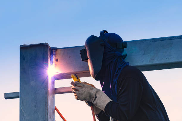 worker welding parts of stell construction - fysisk struktur bildbanksfoton och bilder