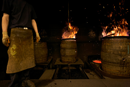 Barrels being reconditioned at a cooperage in Scotland are undergoing the charring process