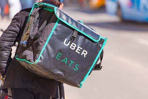 Worker With Uber Eats Bicycle And A Bag In A Street Of Moscow ...