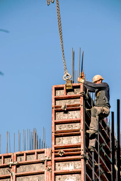Workers are assembling metal formwork during the construction of a residential building. stock photo