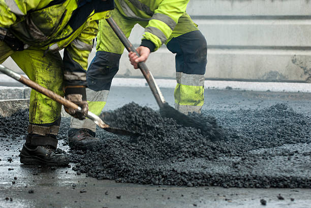 workers making asphalt with shovels at road constructio - byggarbetsplats sverige bildbanksfoton och bilder